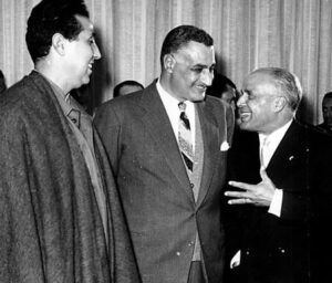 Three political leaders discuss historic meeting, captured in black and white image